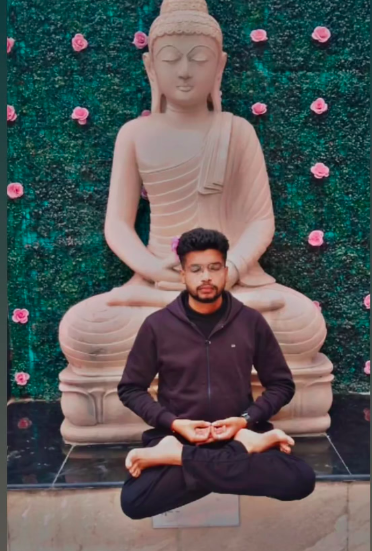 Meditating in front of a Buddha sculpture